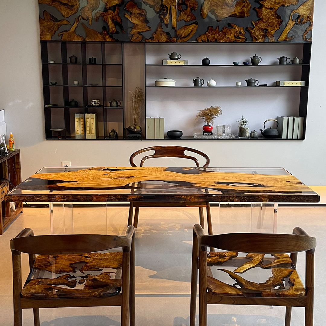 Olive wood and resin table with a wooden chair in the background