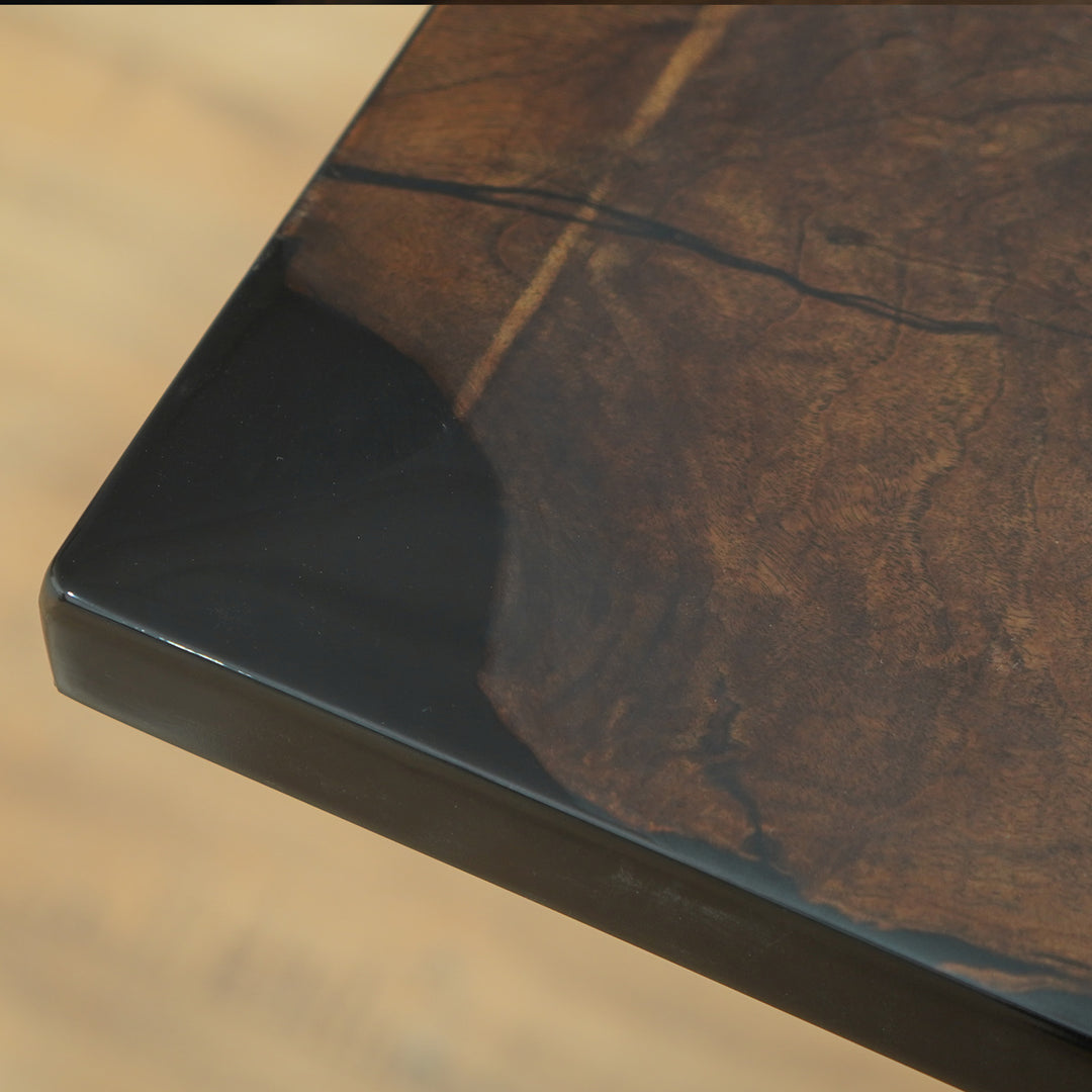 Live edge walnut dining table with opaque black resin river