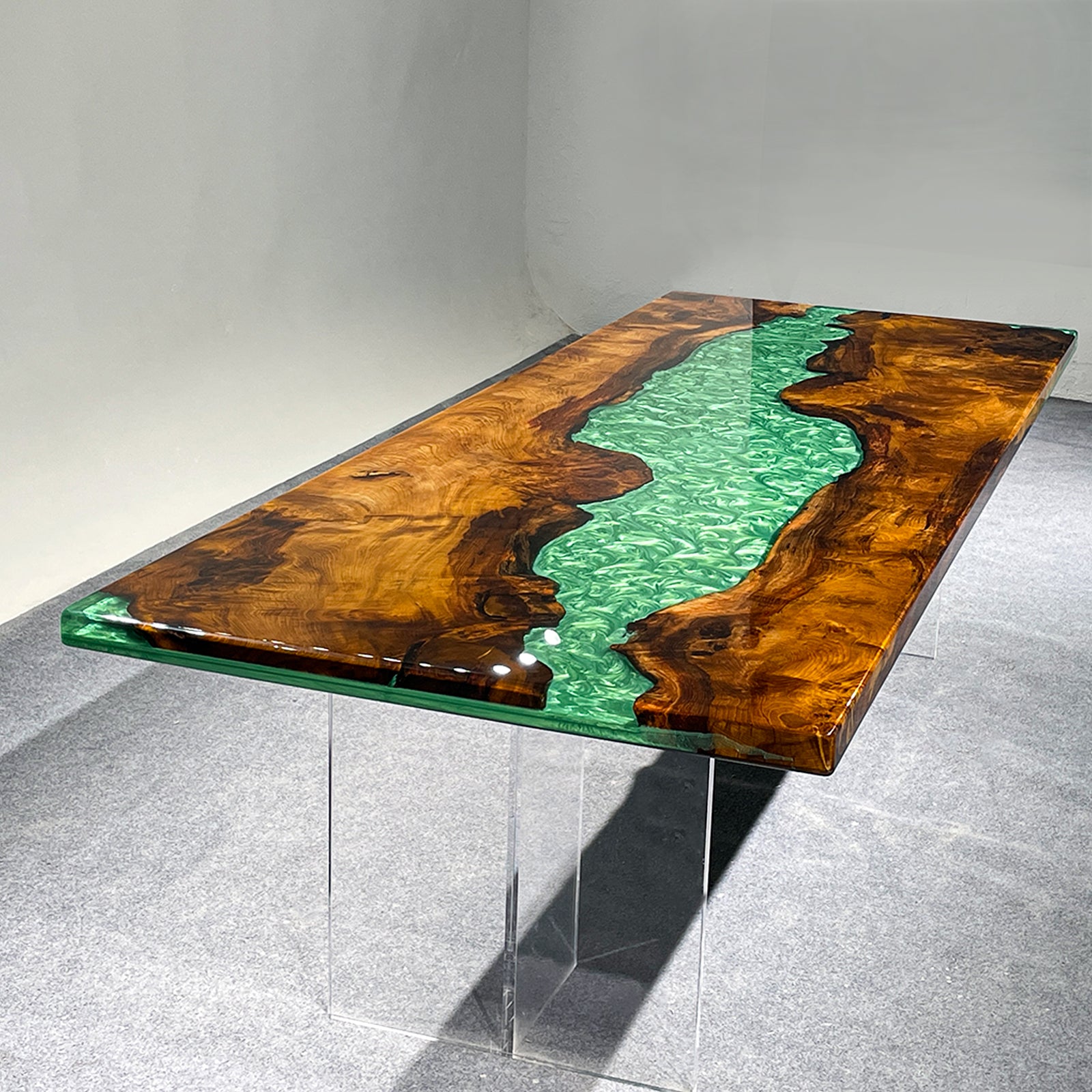 Unique custom river table with vibrant green resin and camphor wood grain