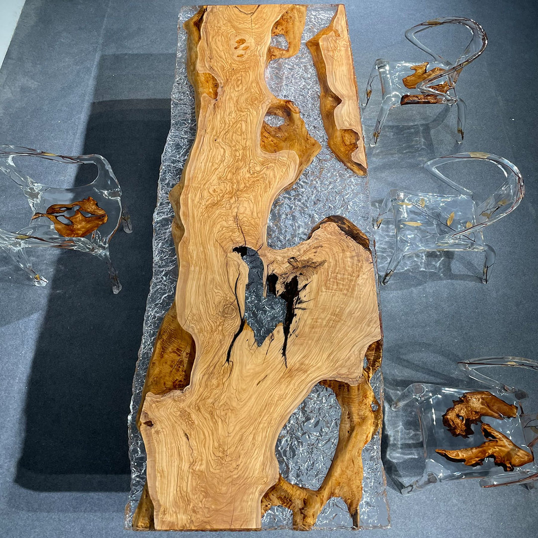 Close - up of an olive wood and resin tabletop, highlighting the unique wood grain and resin patterns
