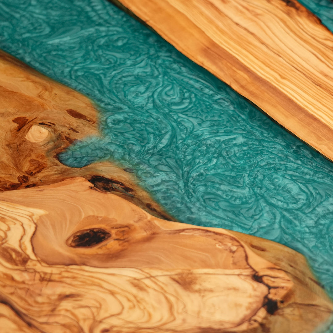 Handcrafted epoxy river table featuring olive wood and vivid resin