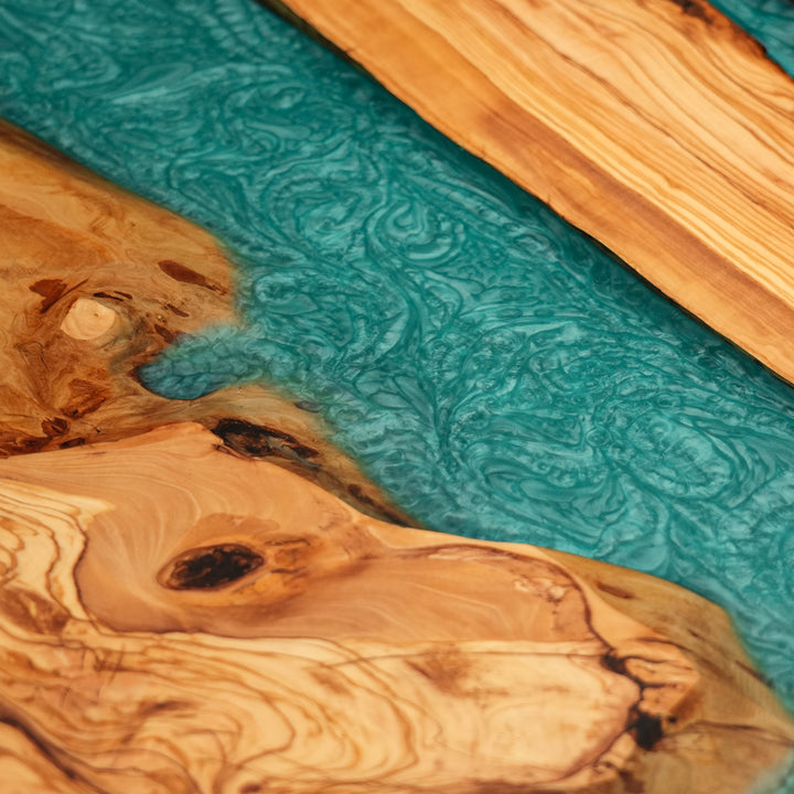 Handcrafted epoxy river table featuring olive wood and vivid resin