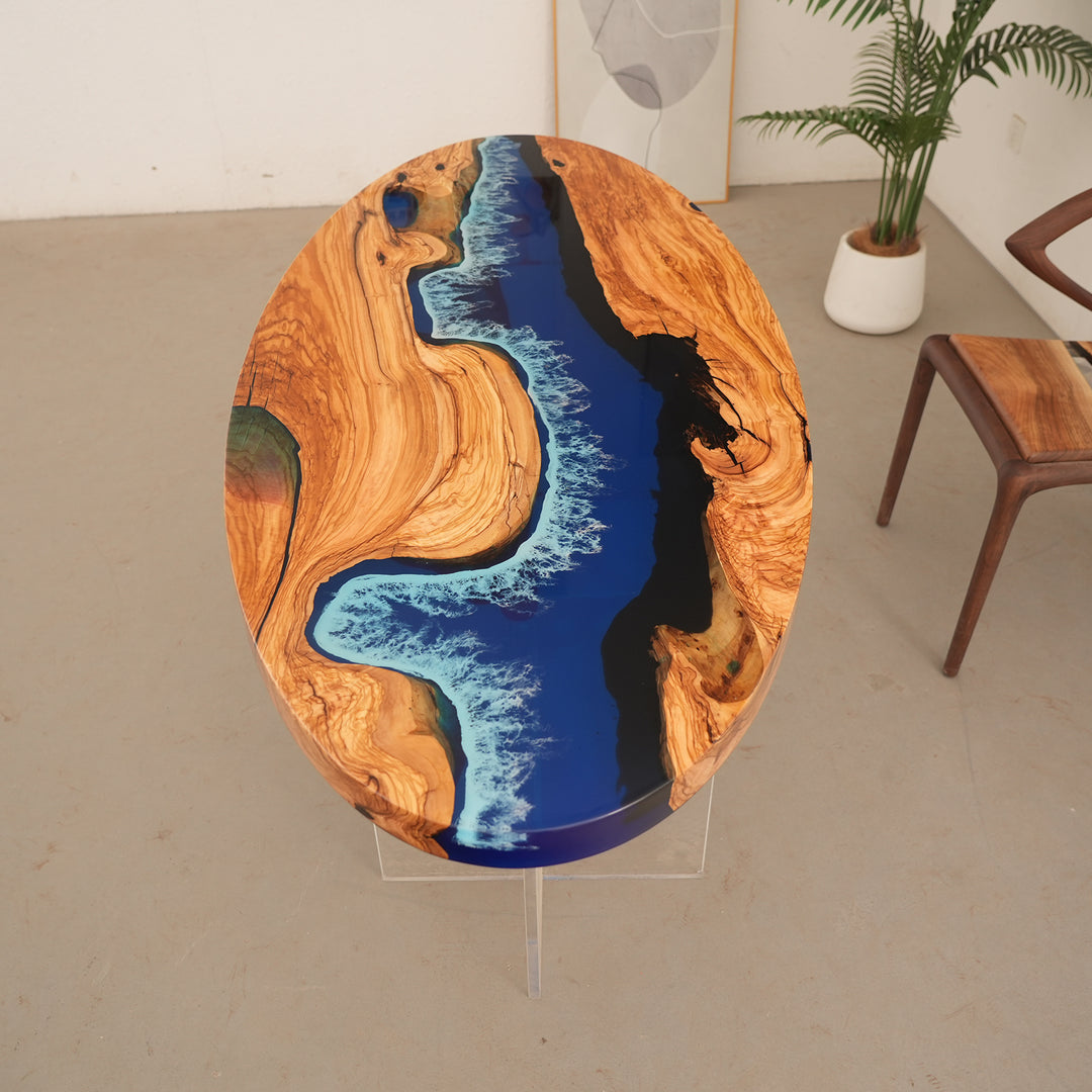 Luxury oval resin table combining warm olive tones with a seascape design