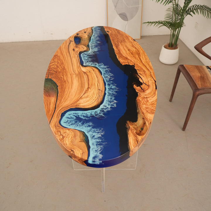 Luxury oval resin table combining warm olive tones with a seascape design