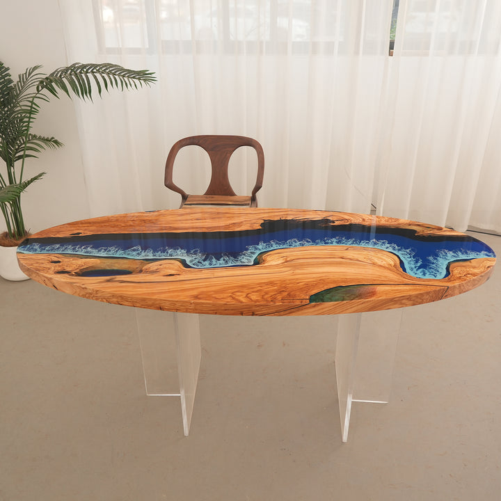 Epoxy art table with translucent blue resin and Mediterranean olive wood slab