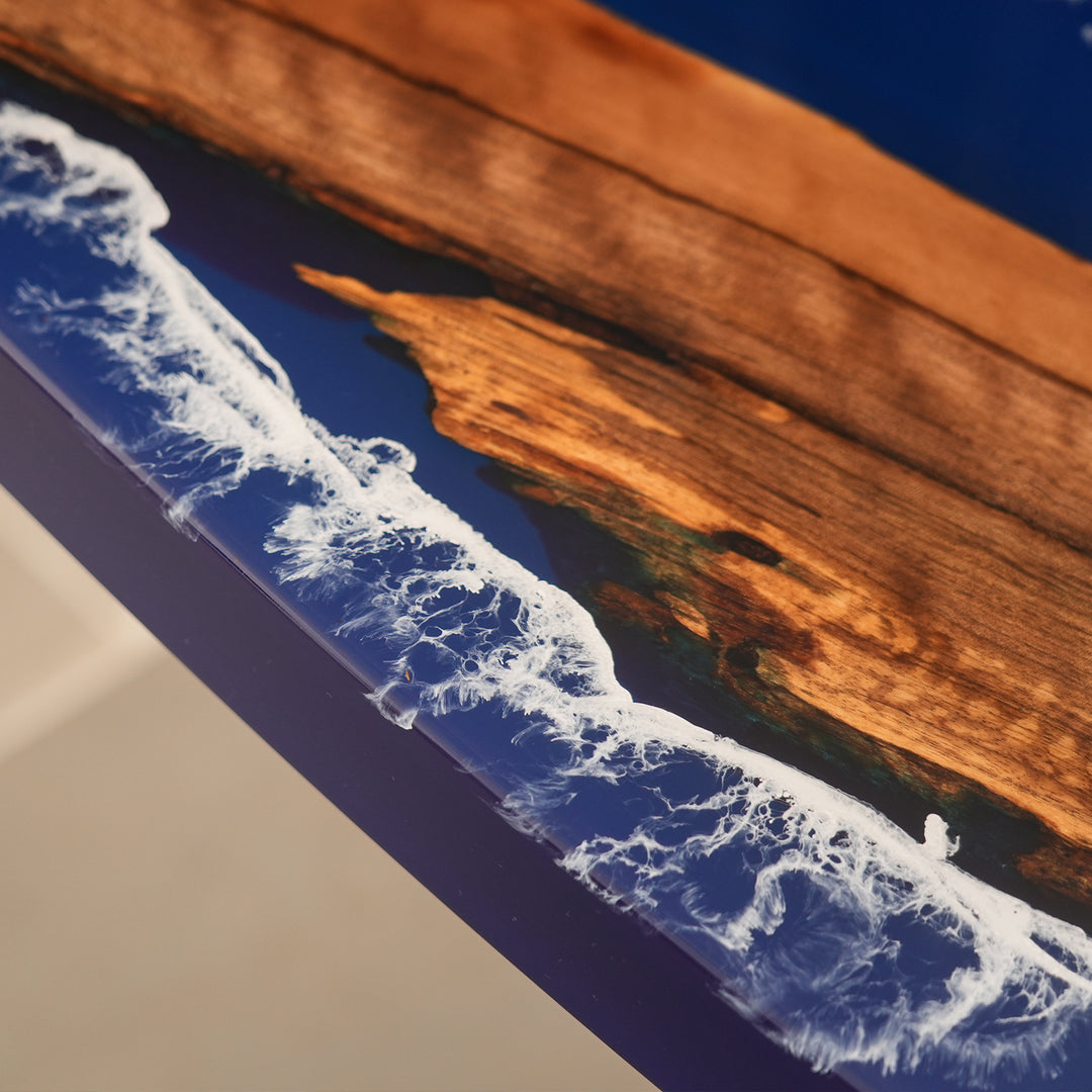 Seawavetable
Epoxy resin dining table with crashing wave effect and rich walnut wood, featured in a cozy holiday setting.