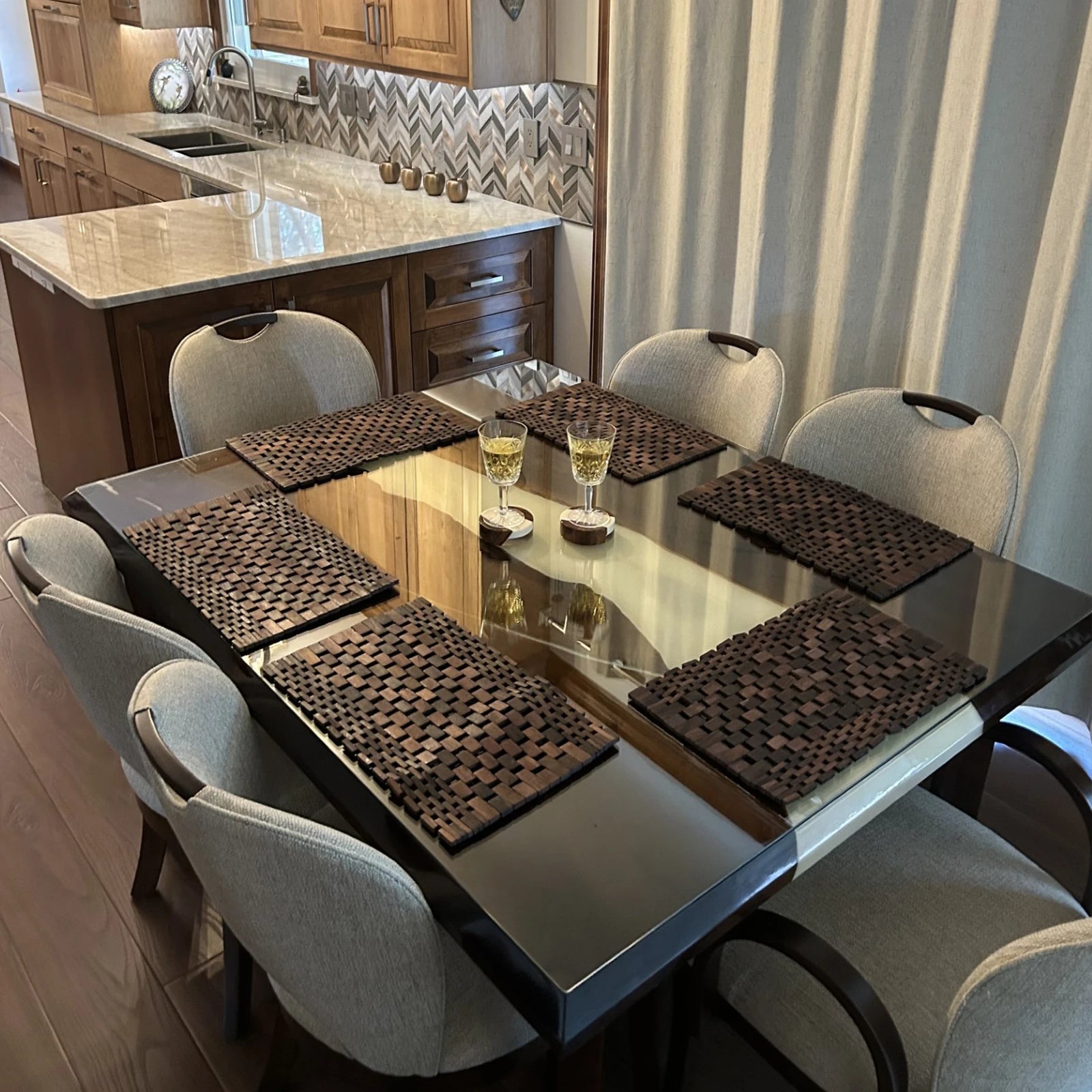 Contemporary black resin table enhancing warm wood kitchen interior design