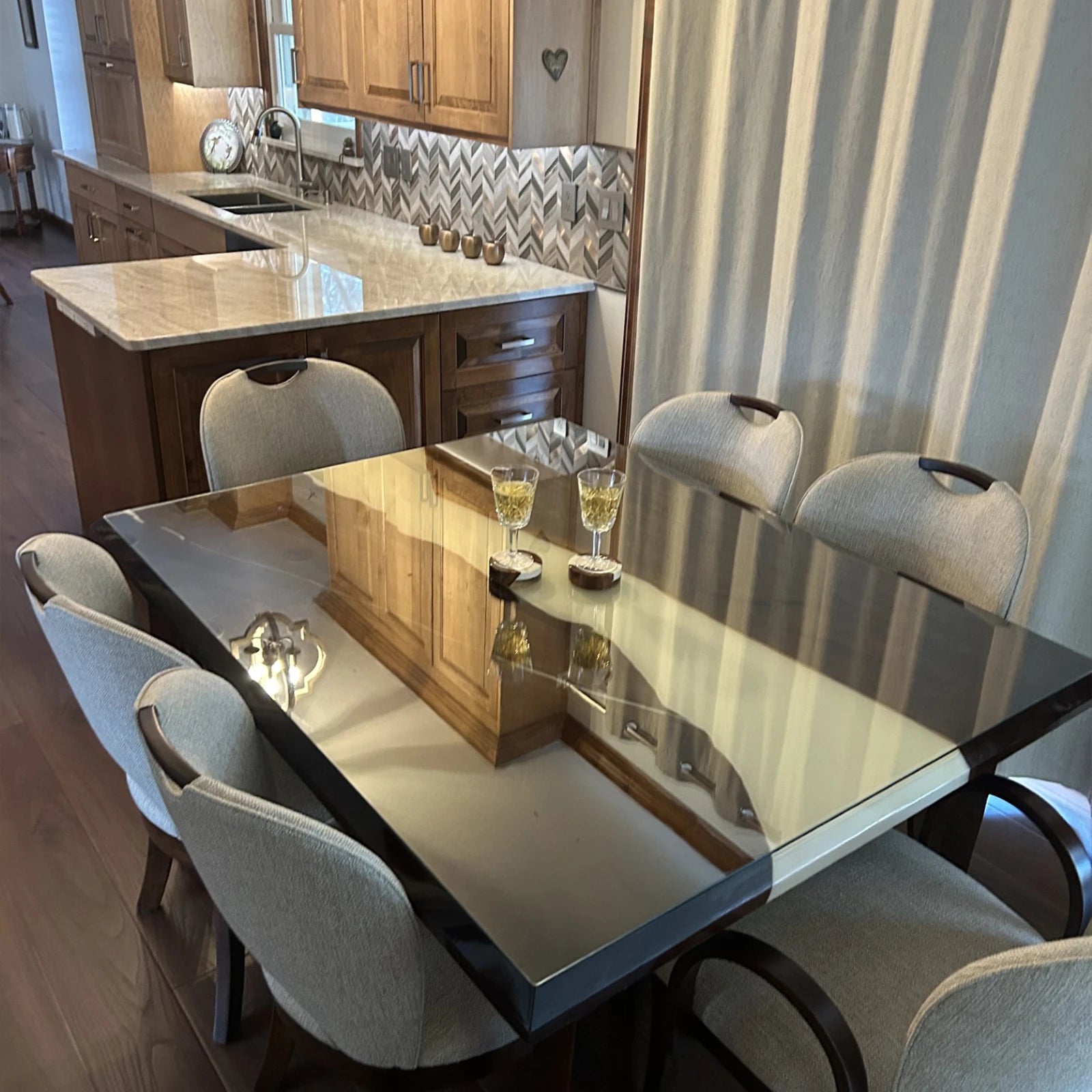 Modern dining room centerpiece with reflective resin surface and elegant lighting reflection