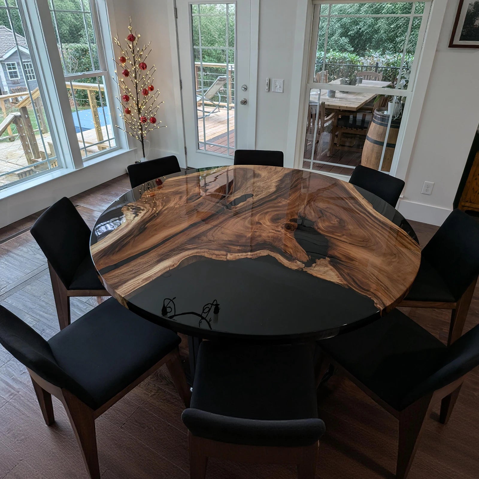 Custom round wood and epoxy table with bold natural patterns and glossy finish