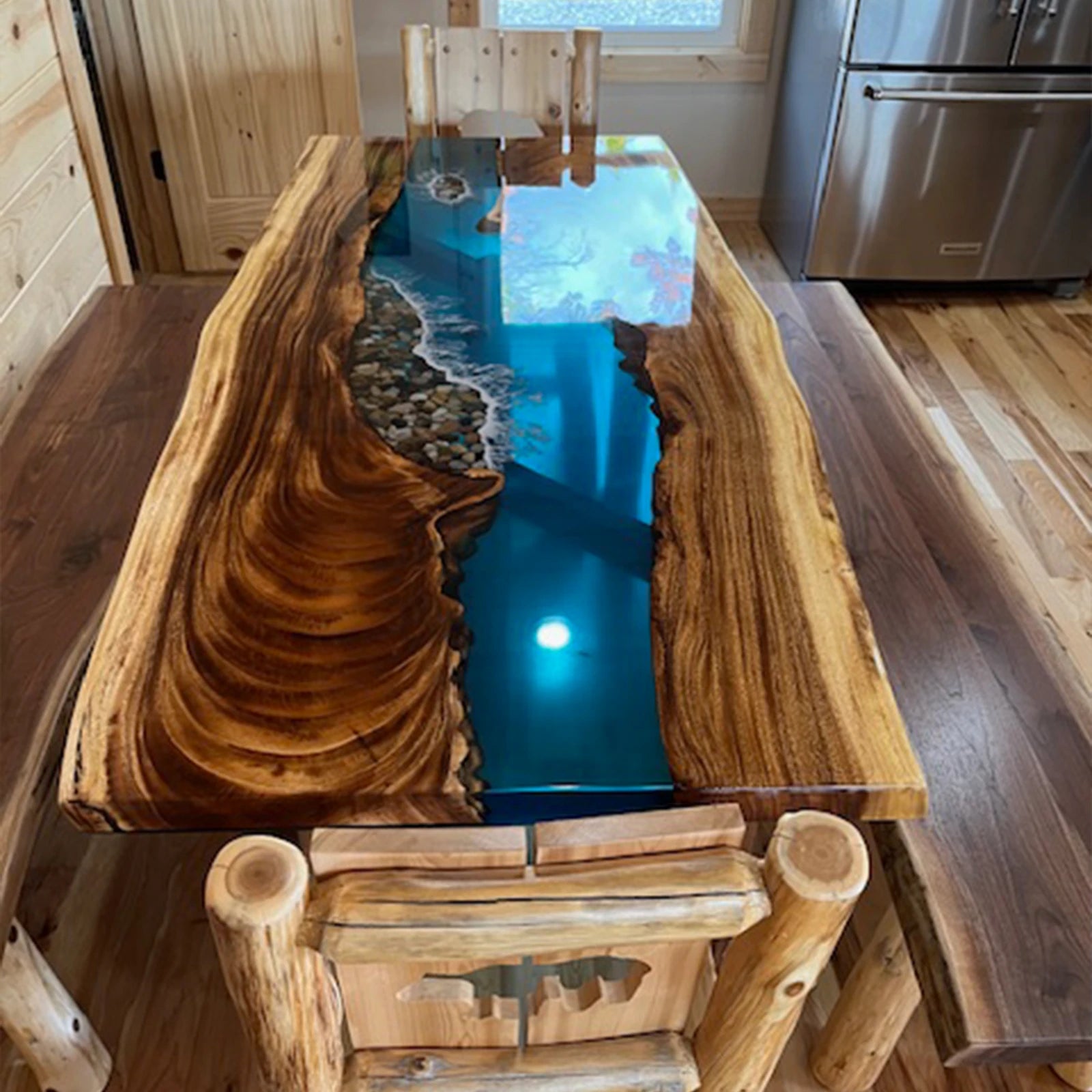Live edge walnut epoxy river table with blue resin and stone inlay in rustic cabin dining room