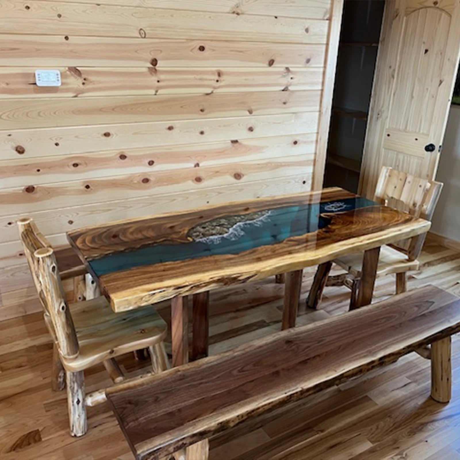Handcrafted wood and epoxy river dining table with natural edge and ocean-inspired resin design