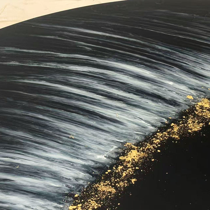 Elegant handmade resin dining table with glossy black surface and metallic gold highlights