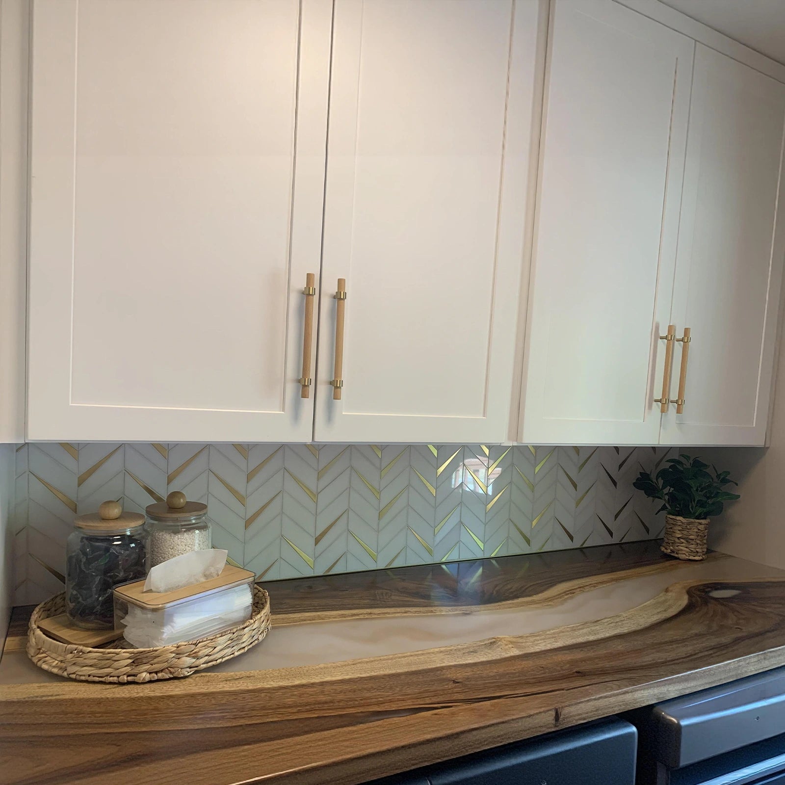 Custom black walnut and Lunar Silk resin countertop shelf with gold resin details used above laundry machines