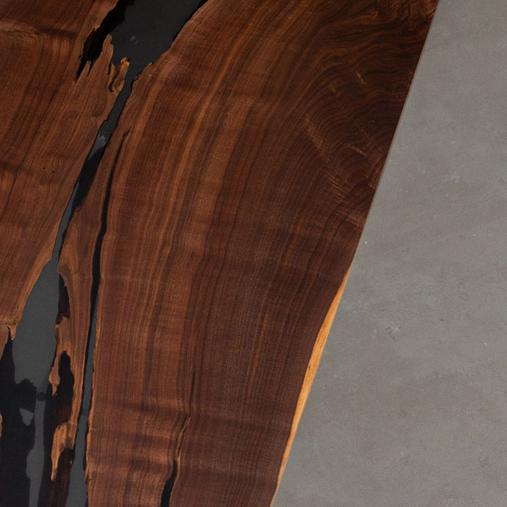 16-foot black walnut and black resin conference table for corporate meeting spaces