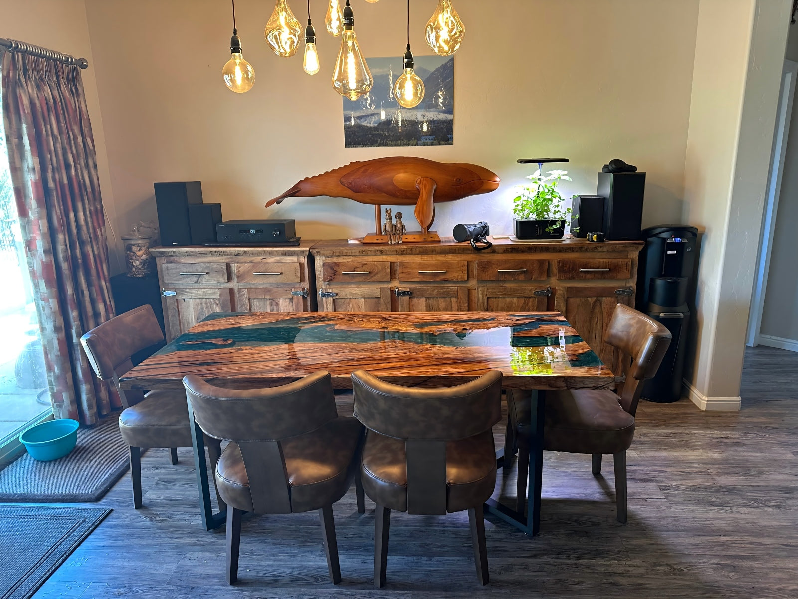 Olive wood epoxy dining table with Mystic Lagoon opaque base and clear resin top, straight edge, glossy finish — handcrafted custom epoxy river table.