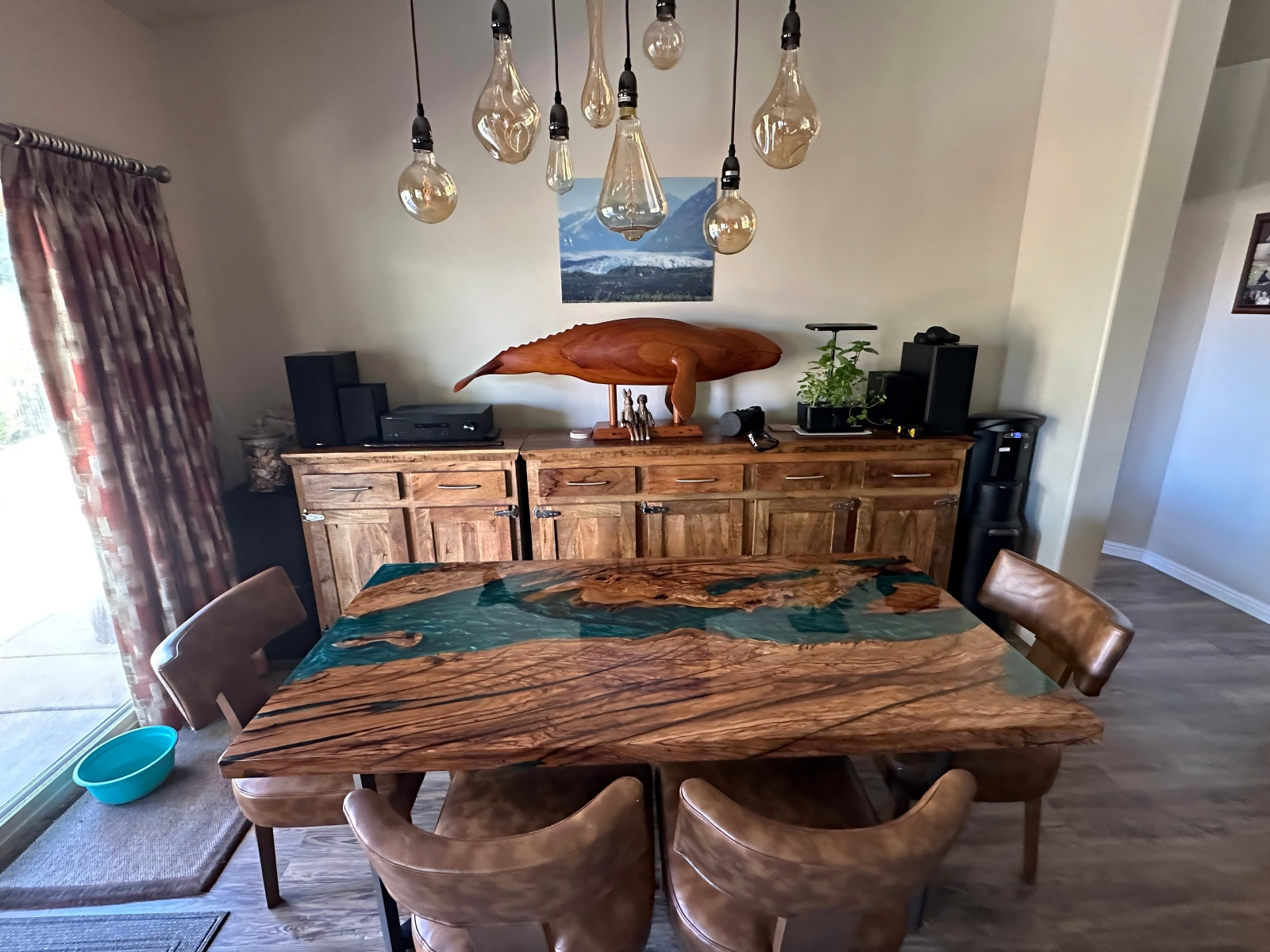 Angled view of olive wood epoxy table with straight edge and high-gloss finish, featuring Mystic Lagoon opaque resin base.