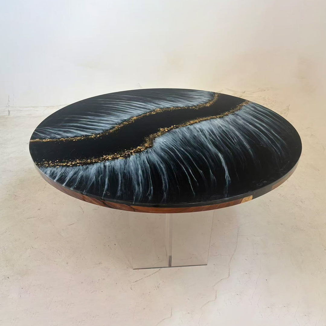 Luxury epoxy resin dining table with black base, white flowing waves, and golden sparkle