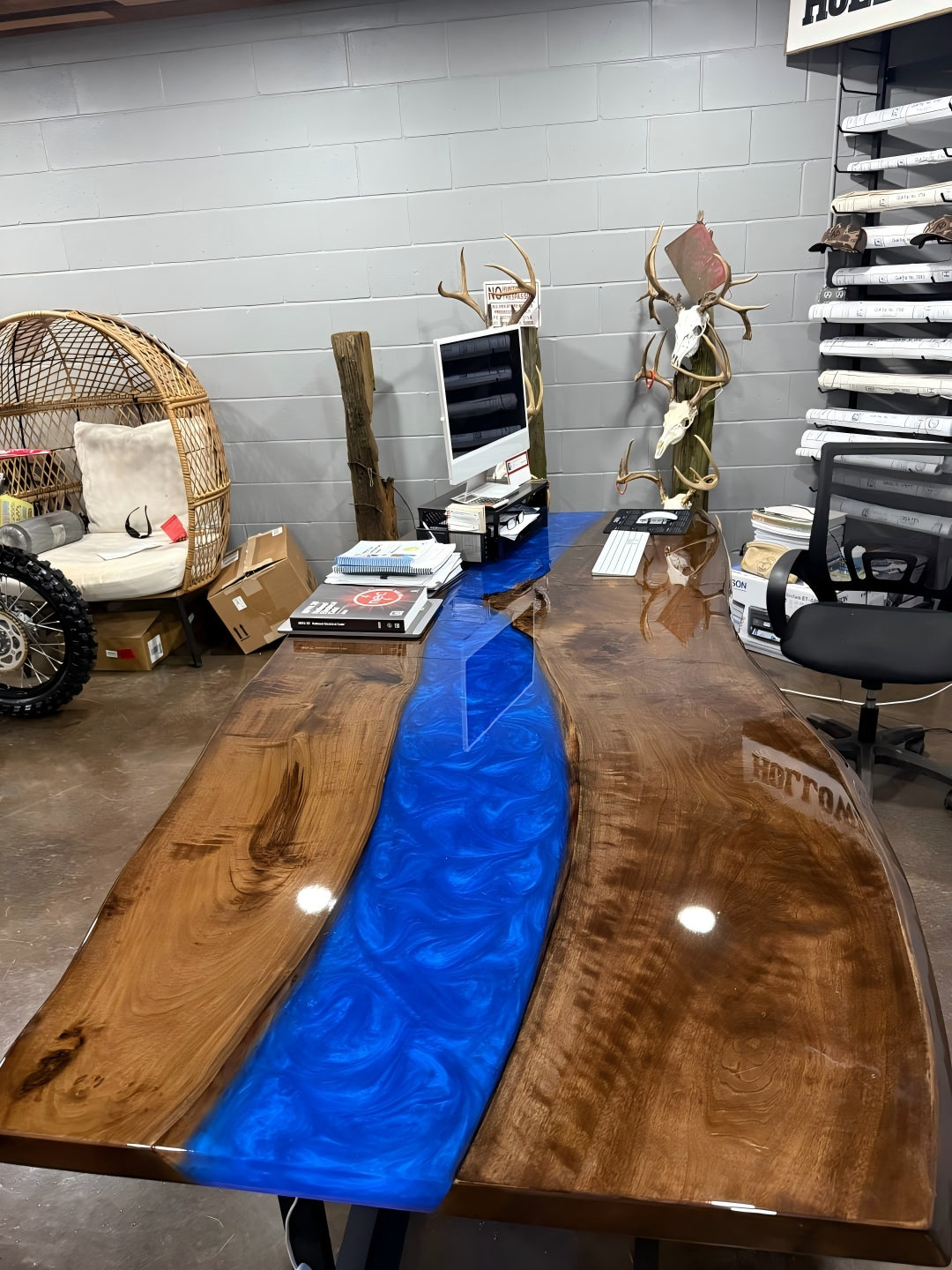 Detail of Swirling Ocean Blue epoxy resin glowing with embedded LED lights, highlighting the natural live edge of black walnut wood