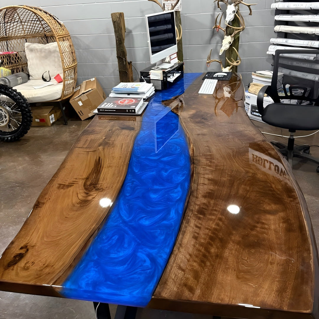 Detail of Swirling Ocean Blue epoxy resin glowing with embedded LED lights, highlighting the natural live edge of black walnut wood