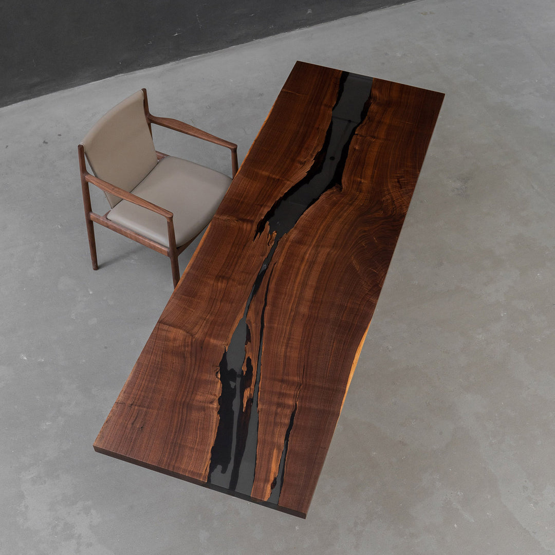 Black walnut epoxy boat-shaped executive boardroom table with refined matte finish.