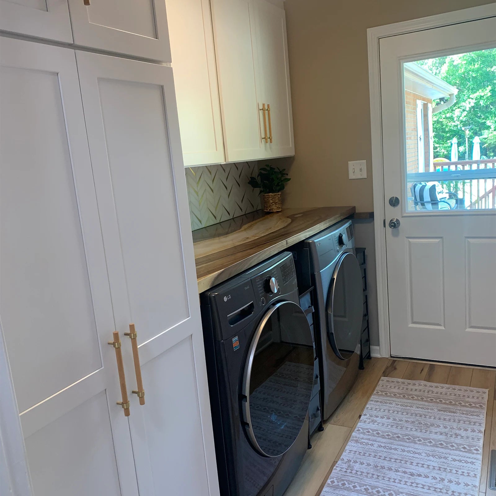 Black walnut shelf with Lunar Silk resin and gold veins installed above washer and dryer in a York SC home by SeawaveTable