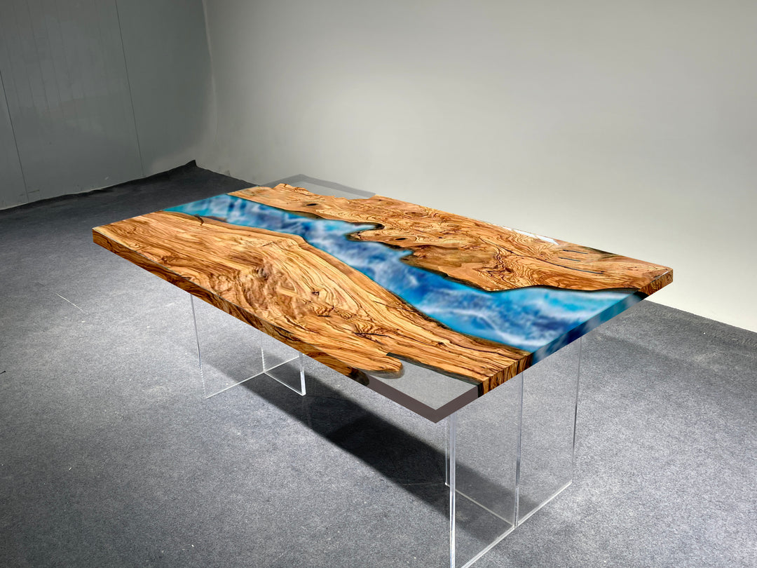 Wooden table with blue resin inlay on a gray floor