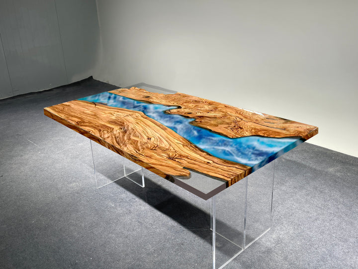 Wooden table with blue resin inlay on a gray floor