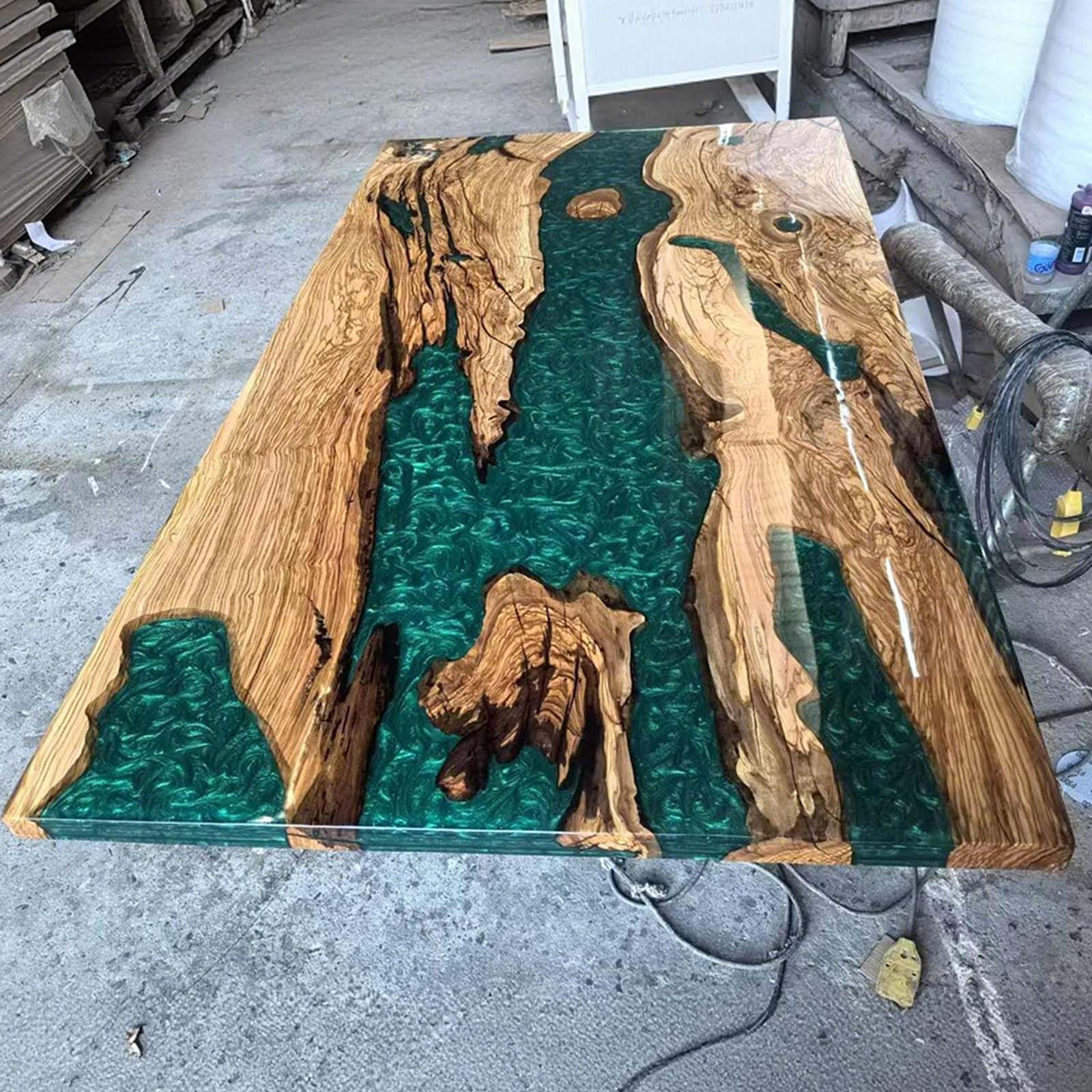 Completed Jade Oasis olive wood dining table with straight edges and glossy finish, ready for installation.