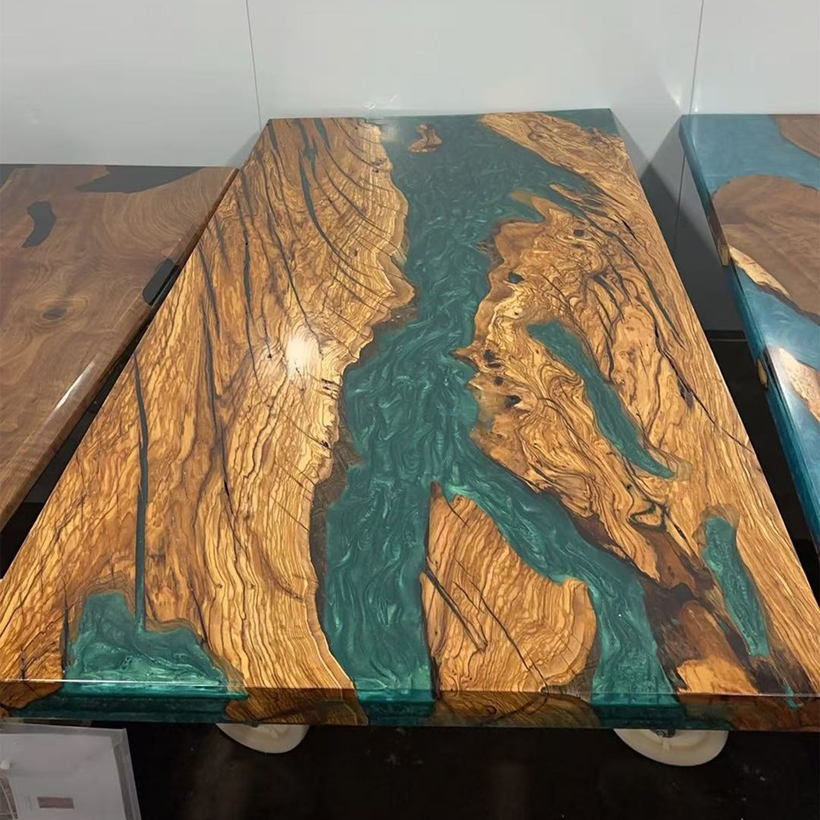 Handmade artisan olive wood epoxy river table combining luxury craftsmanship and nature-inspired art.