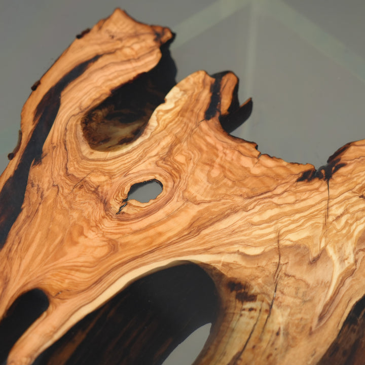 Modern round epoxy river table with olive wood and smoky resin aesthetic