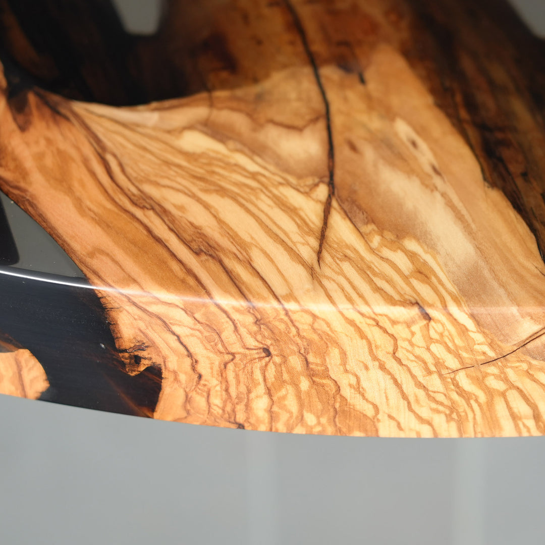 Olive wood round table with resin river and soft reflective surface