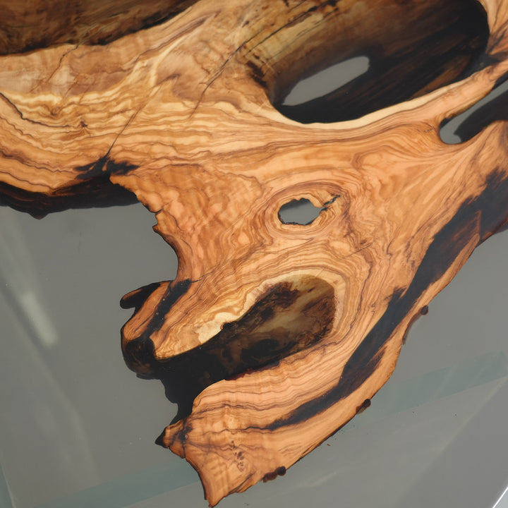 Artisan-crafted olive wood dining table with quartz-like epoxy river