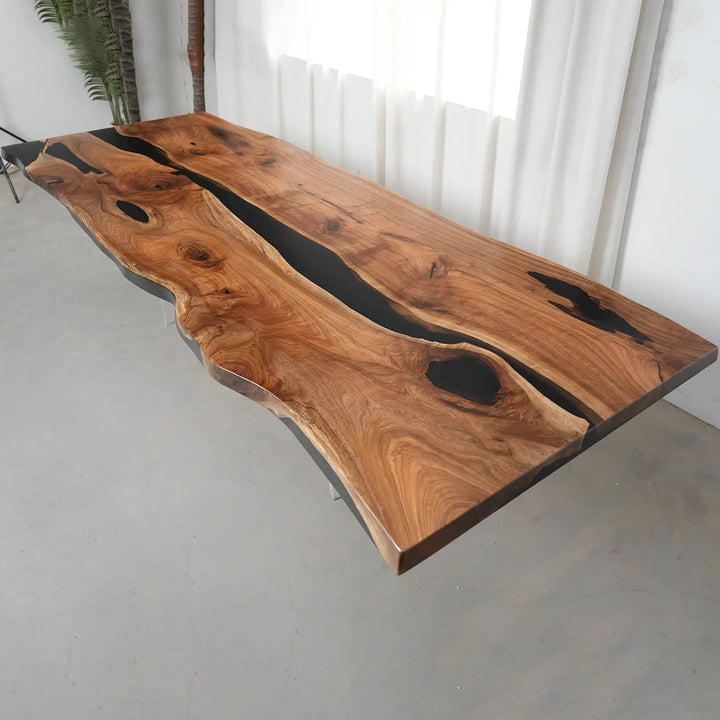 Luxury live edge walnut dining table showcasing natural knots, wood grain variations, and black resin details.