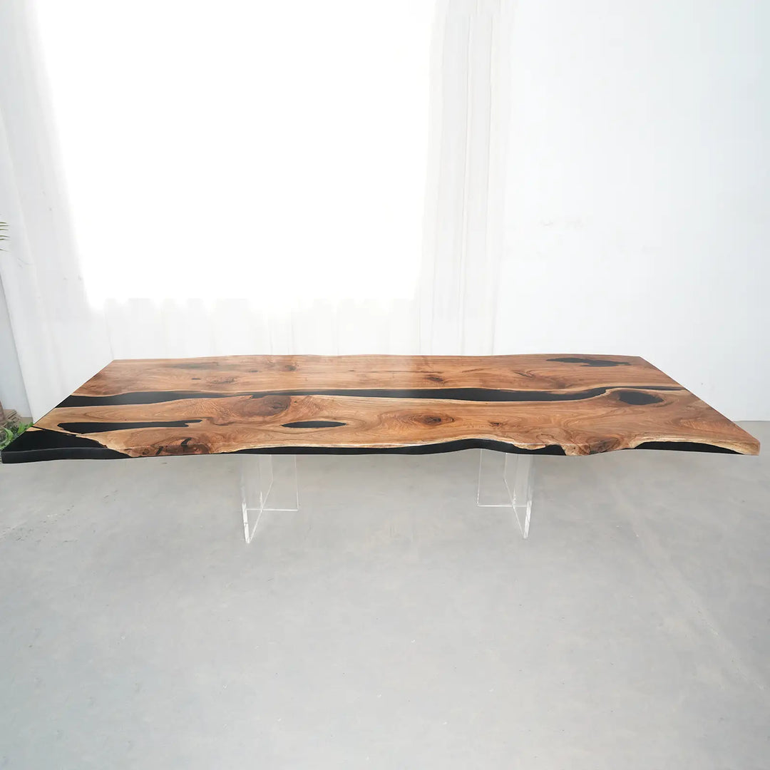 Black epoxy river flowing between two natural black walnut slabs in a handcrafted dining table.