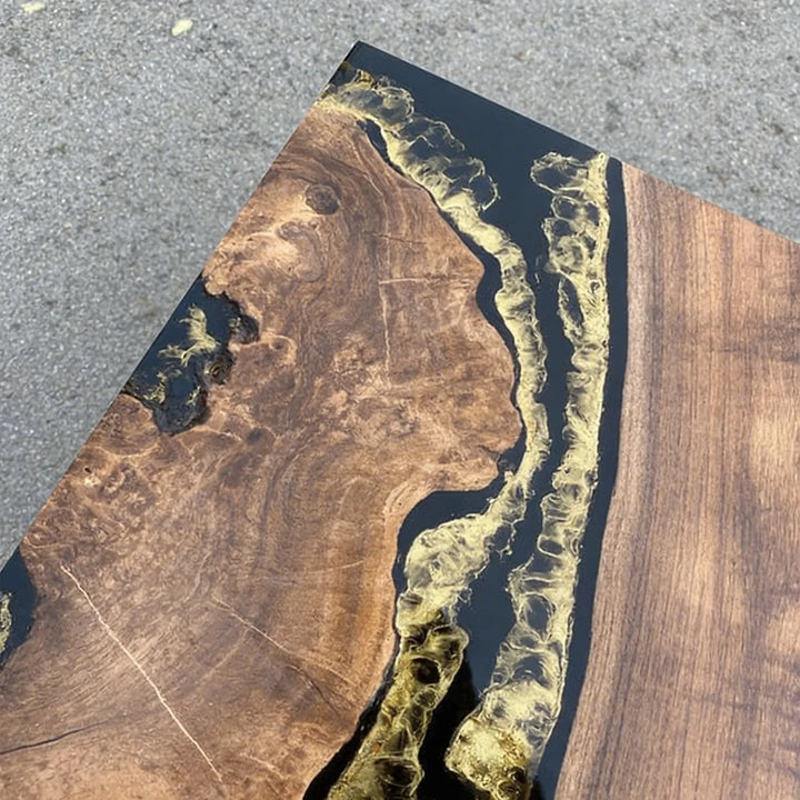 Rustic walnut slab table with black epoxy inlay and gold decorative accents