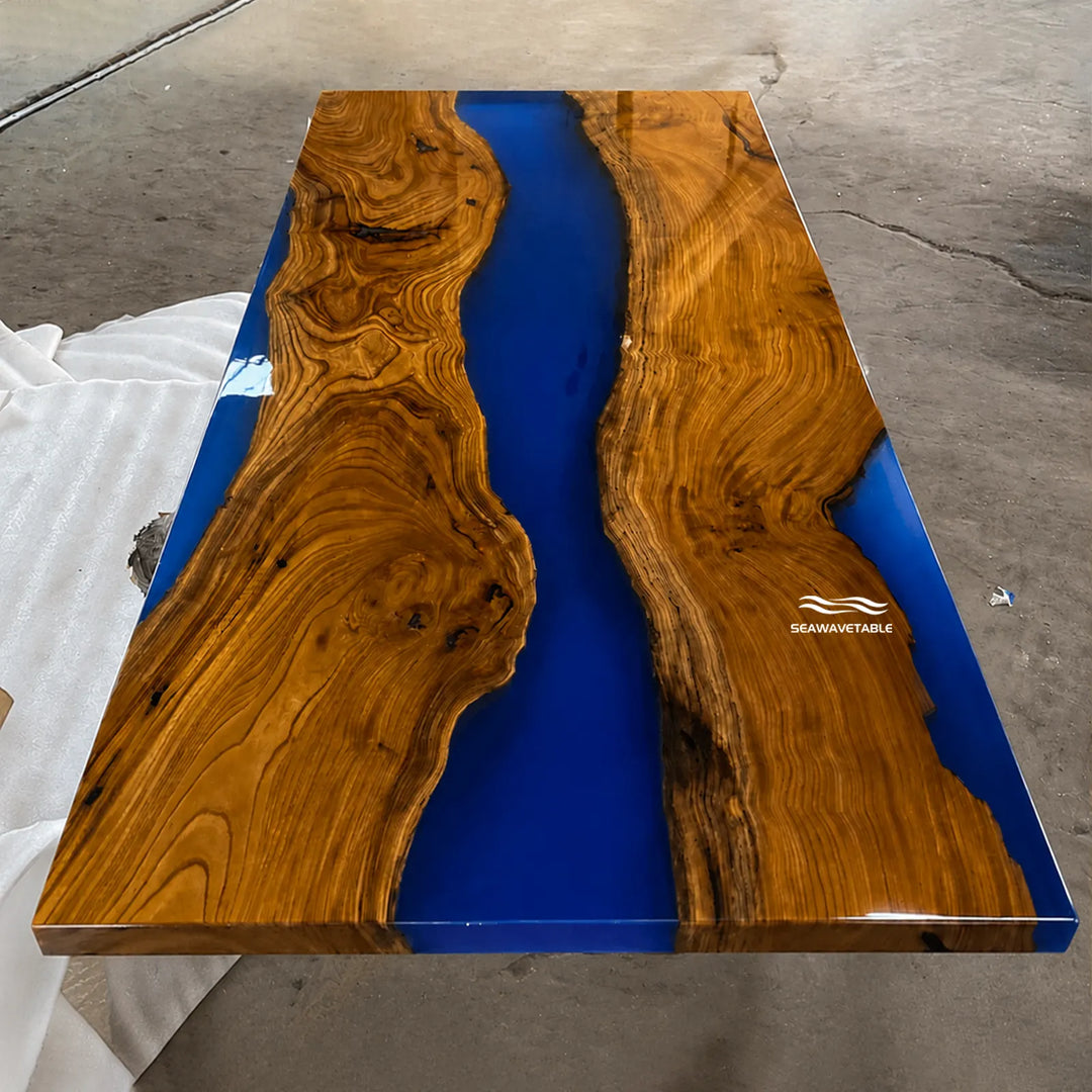 Custom olive wood dining table with artistic blue resin river