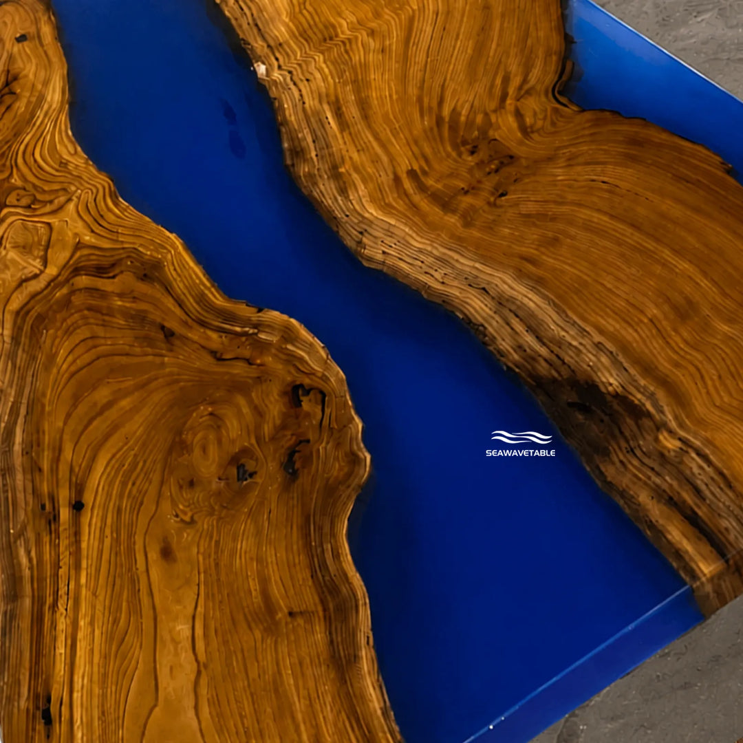 Modern artisan olive wood table with bold blue epoxy centerpiece