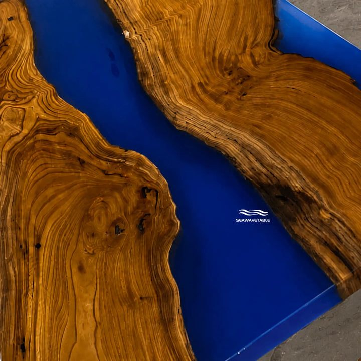 Modern artisan olive wood table with bold blue epoxy centerpiece