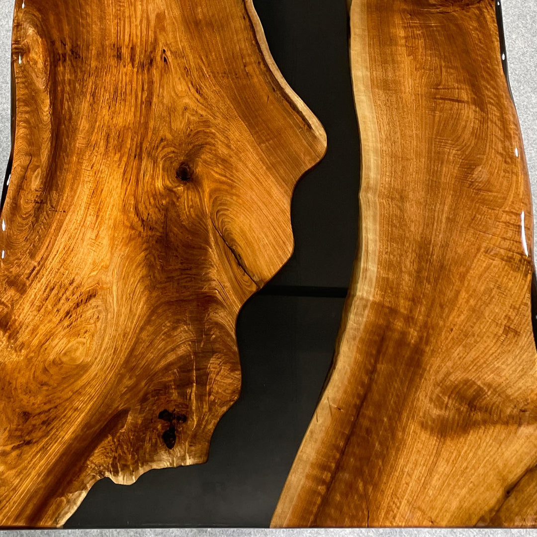 black walnut live edge table with black river epoxy and polished surface