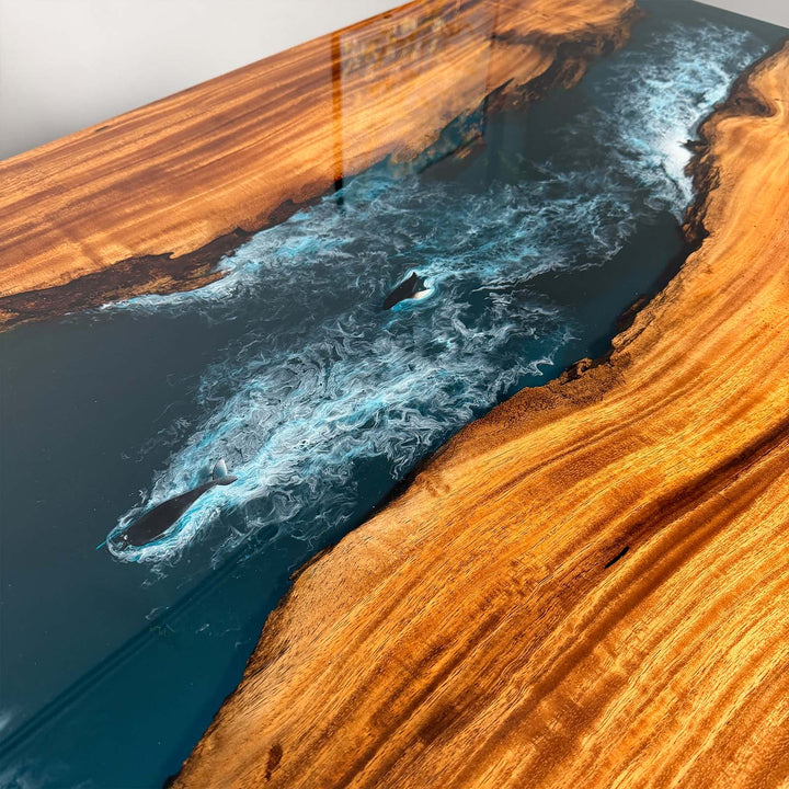 Angle view of the custom navy resin dining table showing structure and color contrast