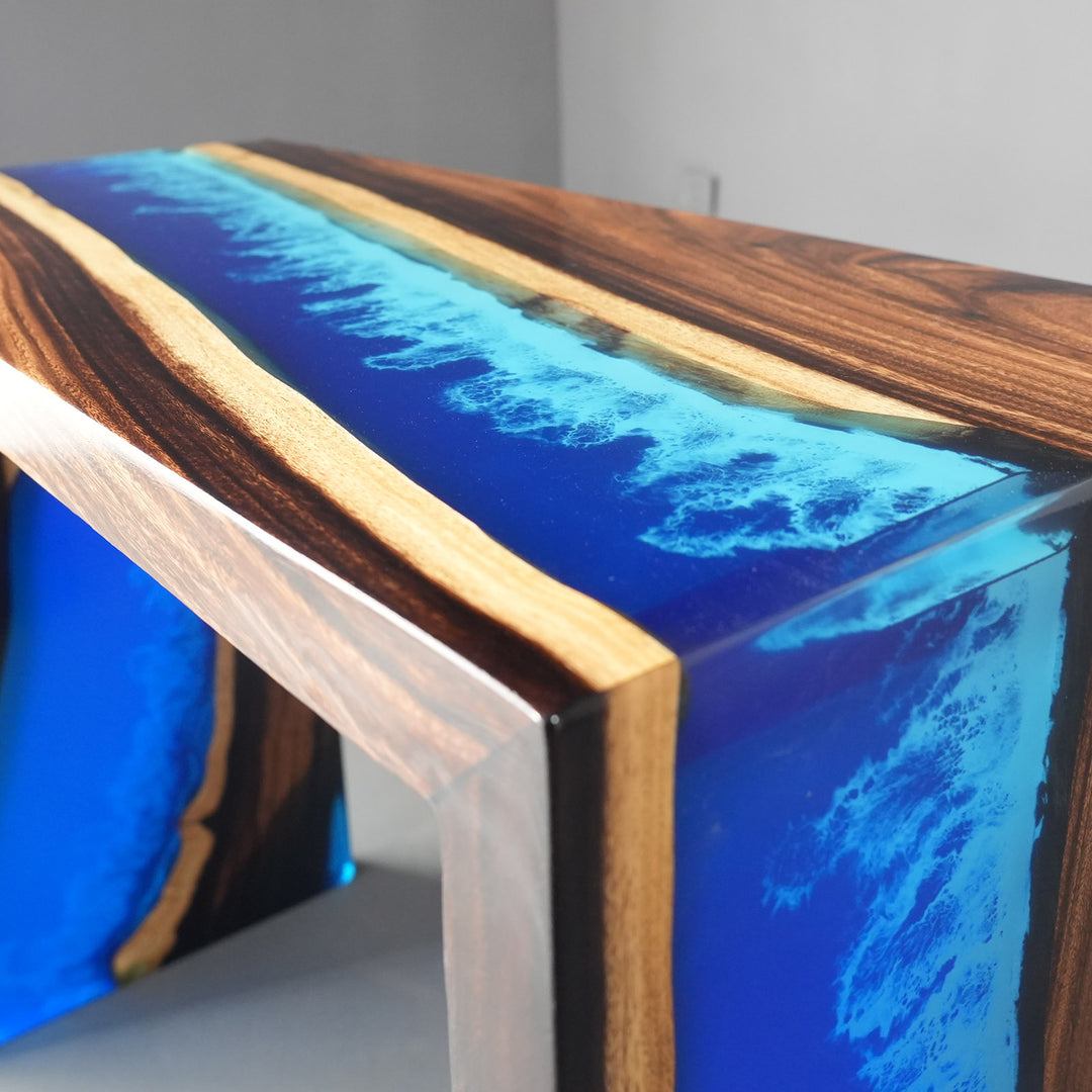 Side view of a 90-degree mitered waterfall resin table for luxury foyers.