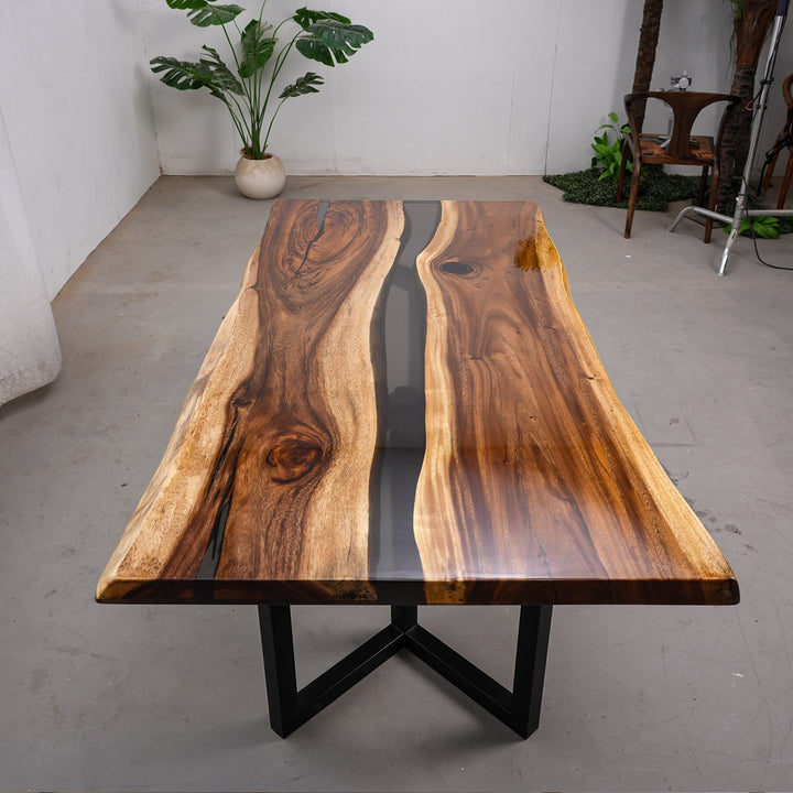 Luxury outdoor dining area featuring a bespoke wood and resin river table by a poolside.