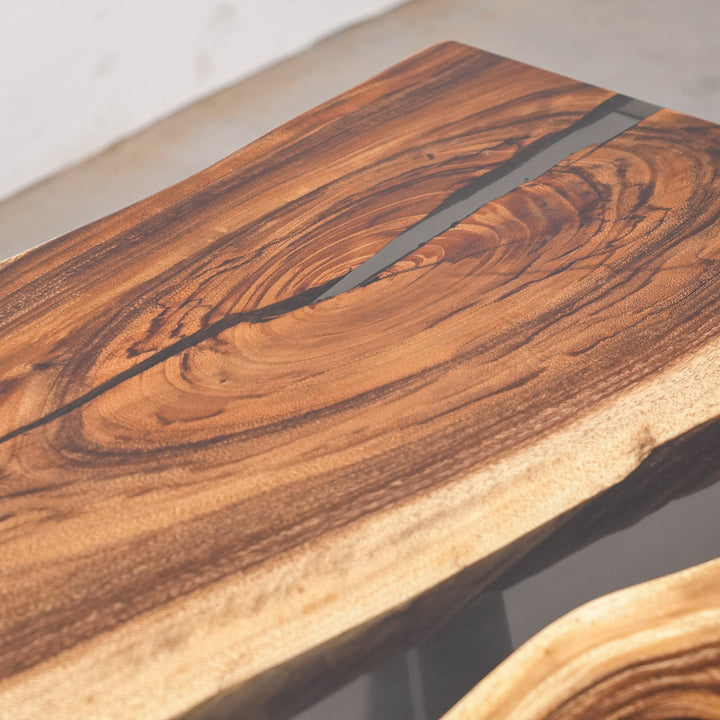 Modern desert-inspired dining centerpiece featuring natural wood textures and sleek black resin.
