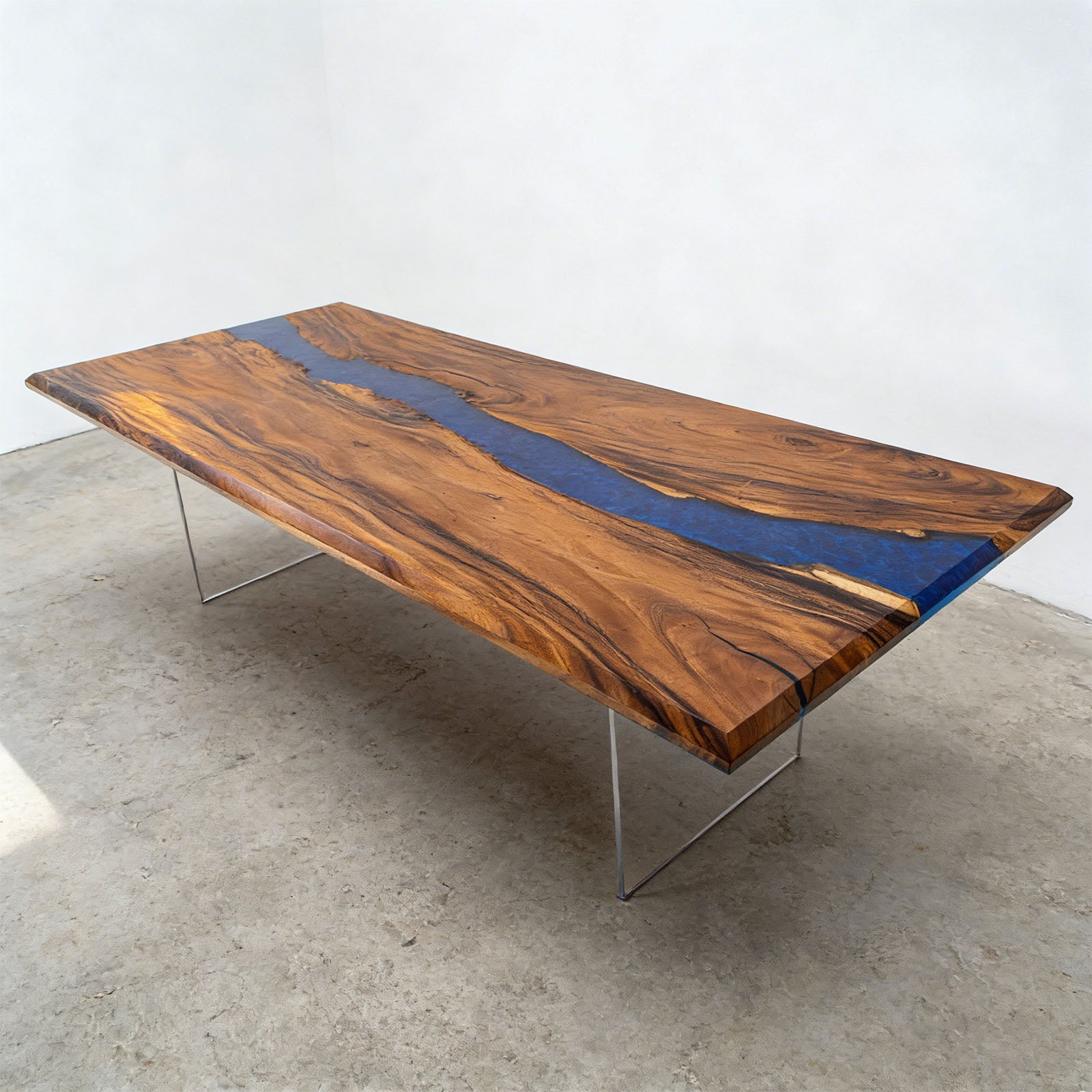 Lifestyle image of a large walnut banquet table with ocean blue resin river, staged in a spacious dining or banquet room.