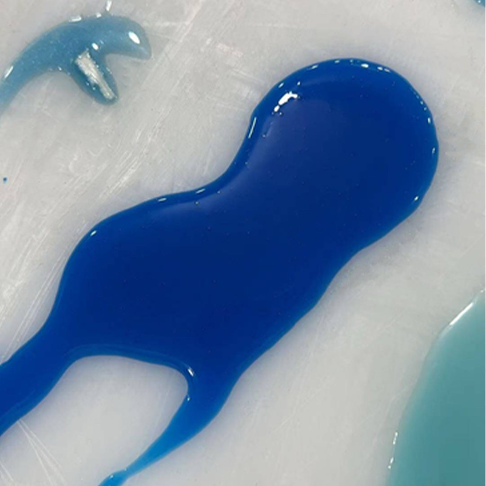 Large walnut banquet table with swirling ocean blue resin river in a modern dining or conference space.