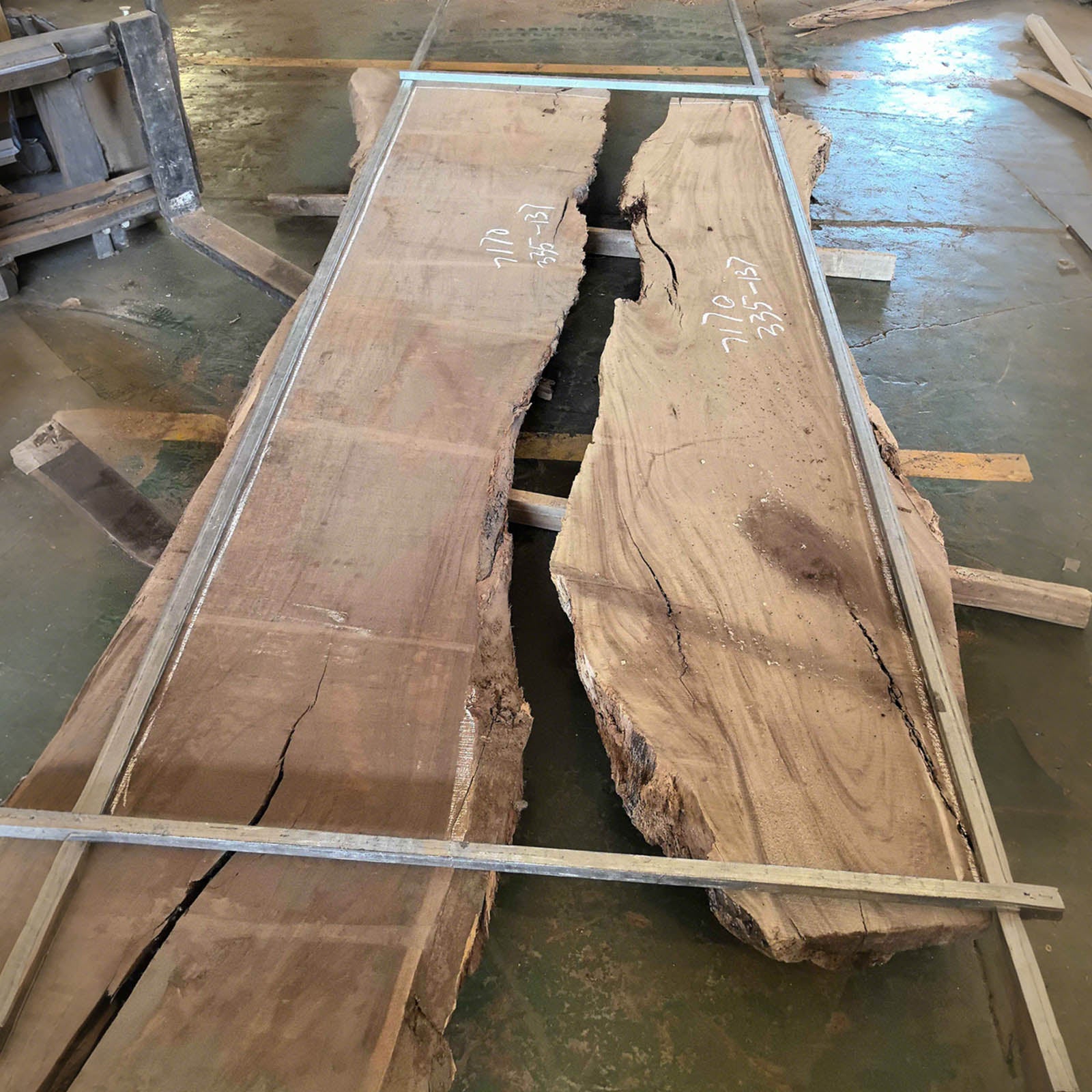 Top view of large handcrafted walnut banquet table with swirling ocean blue resin, showcasing natural wood grain and flowing resin river.