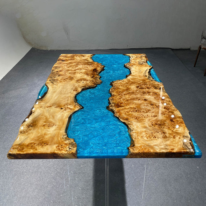 Modern coastal dining table featuring natural poplar wood and resin artwork