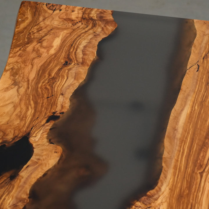 Hand-polished olive wood dining table with matte black resin