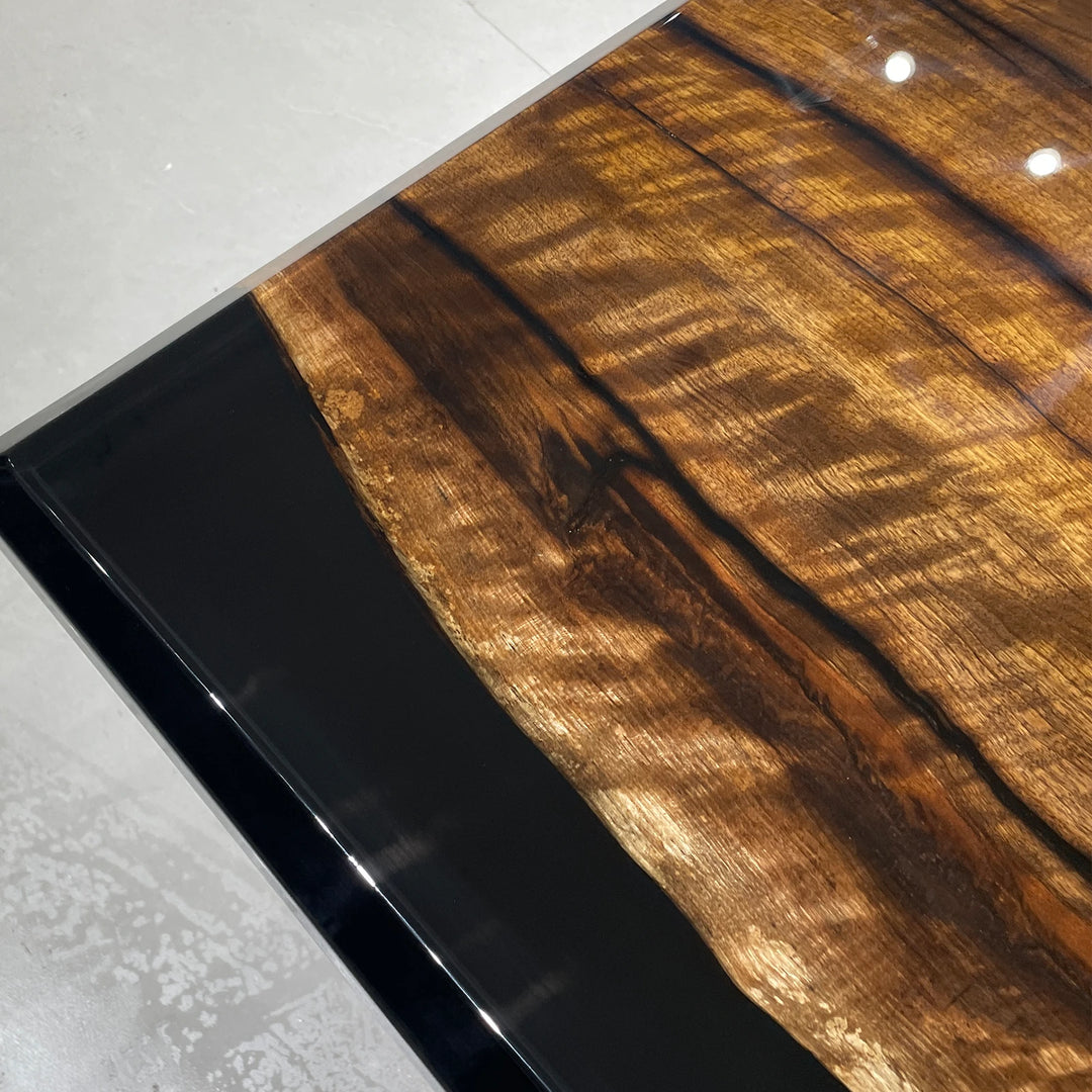 Black epoxy river table for executive boardroom with natural wood grain
