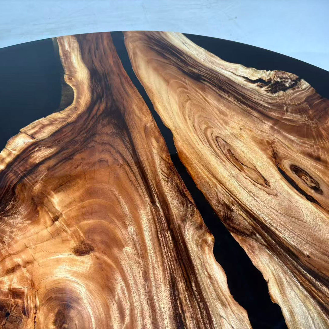 High-gloss round olive wood table featuring black epoxy center